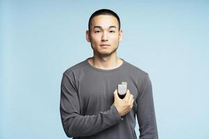 Young man using asthma inhaler for respiratory problems photo