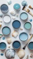 Paint cans and seashells creating a relaxing coastal palette photo
