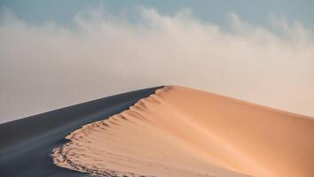 A lone person walking on a sand dune photo
