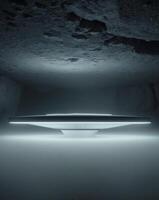 A futuristic looking object in a cave with a light photo