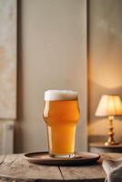 A glass of beer on a wooden table photo