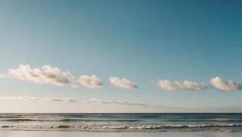 A man is standing on the beach with a surfboard photo