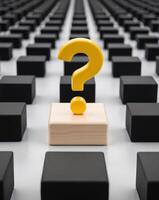 A wooden block with a question mark on it in a large room photo