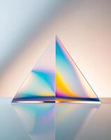 A glass pyramid with a rainbow colored reflection photo
