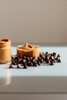 Peanut butter and chocolate chips on a table photo