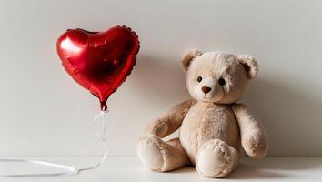 A teddy bear and a heart shaped balloon photo
