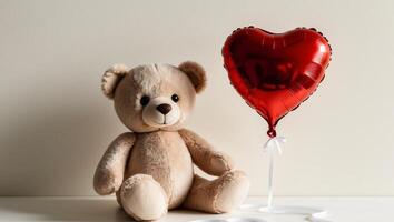 Teddy bear with heart shaped balloon on white background photo