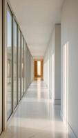 A long hallway with large windows and white walls photo