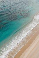 An aerial view of a beach with waves and sand photo