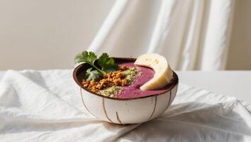 A bowl of purple smoothie with a banana and some nuts photo