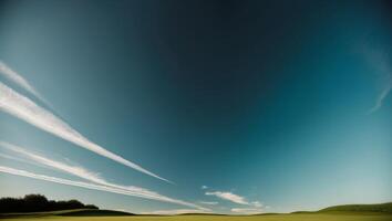 A plane flying over a green field with a blue sky photo
