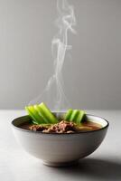 Chicken and celery soup with a steaming bowl photo