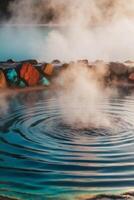 Steam rises from the water in a hot spring photo
