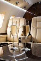Two wine glasses on the table in an airplane photo