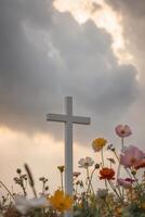 A cross in a field of flowers photo