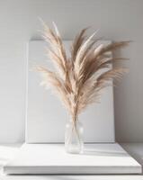 A vase with some pampas grass in it photo