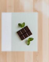 A piece of chocolate on a wooden table photo