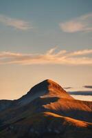 A mountain with a cloud in the sky photo