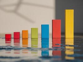 A row of colorful wooden blocks with a reflection of a building photo