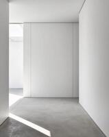 An empty room with white walls and a concrete floor photo