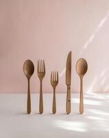 A set of four wooden spoons and forks on a table photo