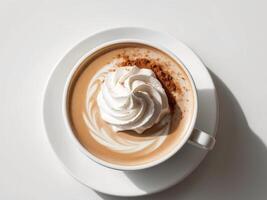A cup of coffee with whipped cream and cinnamon photo