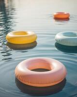 Four inflatable rings floating in the water photo