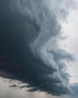 A large storm cloud is seen over a field photo