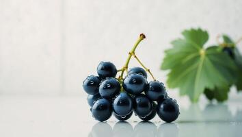 A bunch of grapes on a table with leaves photo