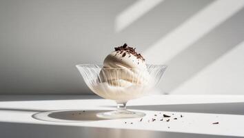 A dessert in a glass bowl with chocolate on top photo