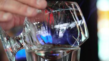 Bartender prepares Sambuca at the bar. Mixing of alcoholic drinks. video
