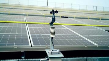 Weather station for measuring wind velocity background solar cells. Alternative source of electricity. Solar farm. video