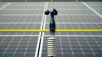 Weather station for measuring wind velocity background solar cells. Alternative source of electricity. Solar farm. video
