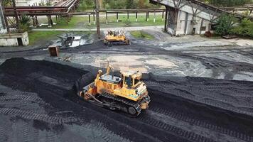 Coal handling operations at the factory. Crawler bulldozer works. Aerial view. video