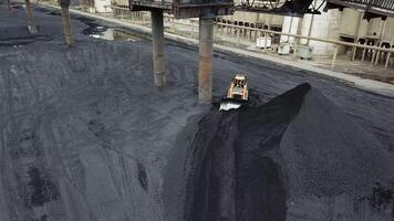 Coal handling operations at the factory. Crawler bulldozer works. Aerial view. video