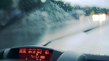 Windshield wipers work during heavy rains. Car dashboard. Close-up video