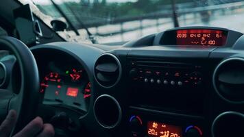 Car dashboard and wet windshield from a heavy rain in a heavy traffic. Close-up video