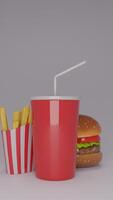 A hamburger and fries in a red cup photo
