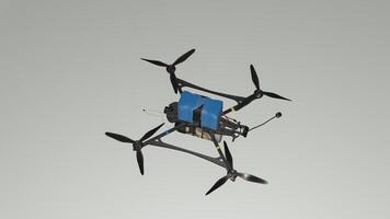 A small drone with propellers and a blue box photo