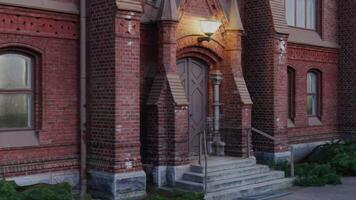 A red brick building with a light on the front door photo