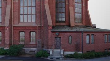 A large red building with a clock on the side photo