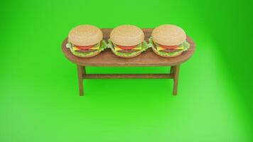 Three hamburgers on a table with a green background photo