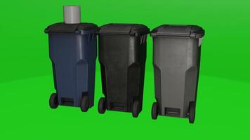 Three trash cans with wheels and handles on a green background photo