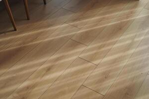 An Exquisite Beautiful Wooden Floor That Is Enhanced by Intriguing Shadows Cast from Natural Light photo