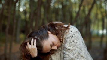Sunny autumn day in park. Young woman spending time in autumn park video