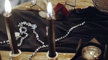Witch at table. Portrait of woman dressed in witch style sitting by the table video