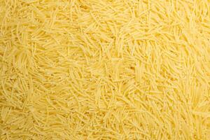 Uncooked Filini Pasta. A Culinary Canvas of Noodles, Creating a Lively and Textured Background for Gourmet Cooking. Dry Pasta. Raw Macaroni - Top View, Flat Lay photo