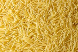 Uncooked Filini Pasta. A Culinary Canvas of Noodles, Creating a Lively and Textured Background for Gourmet Cooking. Dry Pasta. Raw Macaroni - Top View, Flat Lay photo