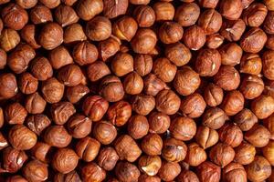 Scattered Peeled Hazelnut - Top View. Background from Hazelnuts. Natural High-Calorie Snacks photo