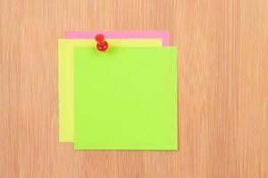 Colored Sticky Notes with Copyspace Pinned to the Wooden Message Board. To Do List Reminder in Office. Blank Memo Sticker at Work - Template. Empty Checklist - Mockup photo